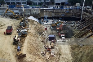 Contractors work at the site of the new Fannie Mae headquarters under construction in Washington, D.C., U.S., on Wednesday, Aug. 17, 2016. The hole at the corner of 15th and L streets, in downtown Washington, is deep -- and getting deeper. Earth-movers there are digging the foundations of a shiny new headquarters for Fannie Mae, the bailed-out giant of American mortgages. Photographer: T.J. Kirkpatrick/Bloomberg